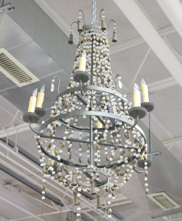 Antique Wood Bead and Crystal Drop Chandelier: French antique Chandelier with strings of wooden beads and crystals and carved bell shapes. Some pieces missing. Iron Frame. Property of Rowayton, CT decorator estate. Measures approx. 3 1/2 feet long