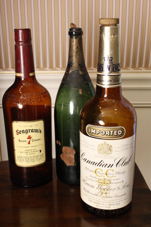 3 Advertising display Liquor Bottles: Vintage display bottles includes Lansaw 1926 Champagne with partial label Seagrams and Canadian club both with dark caramel glass and full labels. Tallest measures app 20 inches high