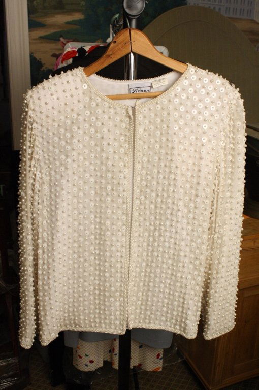 Vintage Beaded Sweater: White vintage sweater with hand beading full coverage.of seed pearl beads and disc shaped sequins. Triple Pearl like border at neckline, sleeve and waist trim. Hand made. Size 6. Label Steinay, made i