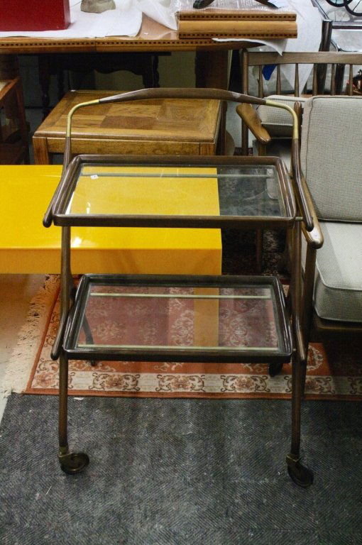 Mid Century Sculptural Danish Bar Cart c. 1950s: A rare sculptural Danish Barcart c. 1950s. Made of sculpted wood and brass with glass surfaces. A very unique piece.