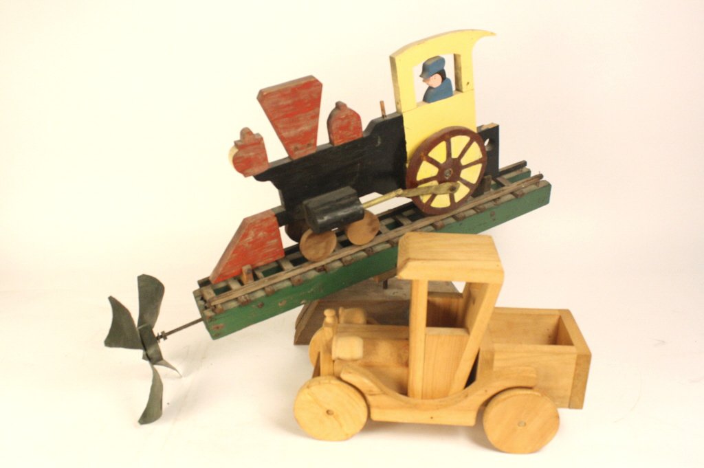 Folk art carved car and train windill: Whimsical Windmill Yellow hand carved painted folk art sculpture of antique train on stand. Possibly antique. mounted on metal base. Measures 32 inches length by 21 inches height Metal on track and si