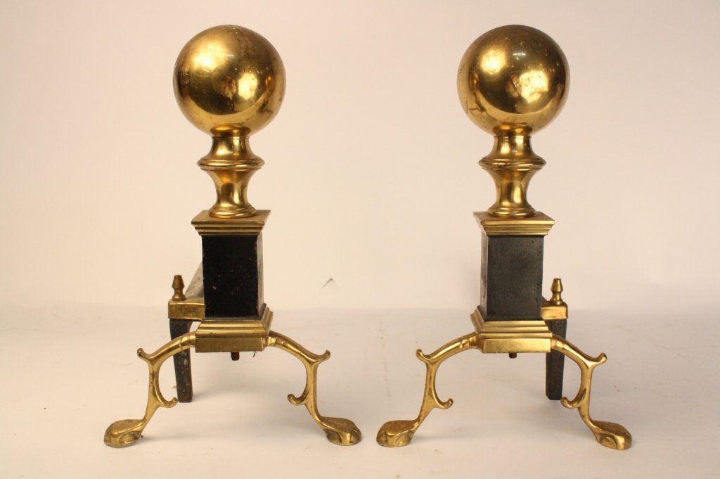 Pair of Bronze Andirons: Cannonball top and articulated stands. Measures 19 inches high and 11 inches wide and 15 inches deep.