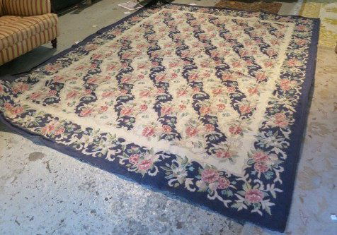 BILL BLASS Chain Stitch Carpet Made in India: Navy blue boarder with pink flowers. Measures 8.6 by 11.6 ft.