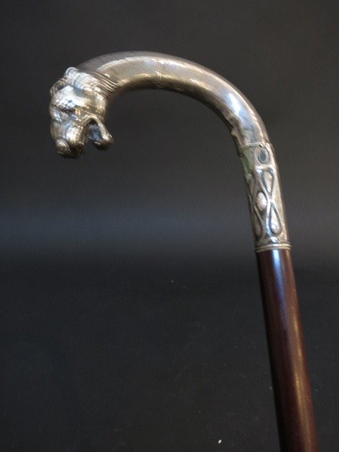 Antique Sterling Ebony Loin Cane: An antique sterling and ebony lion cane. Measures about 34 inches.