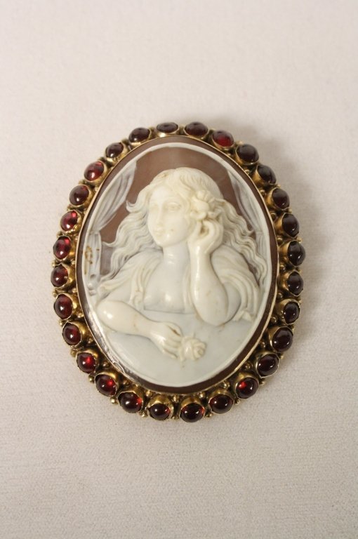 Antique Victorian 14kt Gold Cameo w. Garnets: Large antique 14kt gold cameo ringed with garnet cabochons c. 19th c. Measures roughly 2 1/2 x 2 inches.