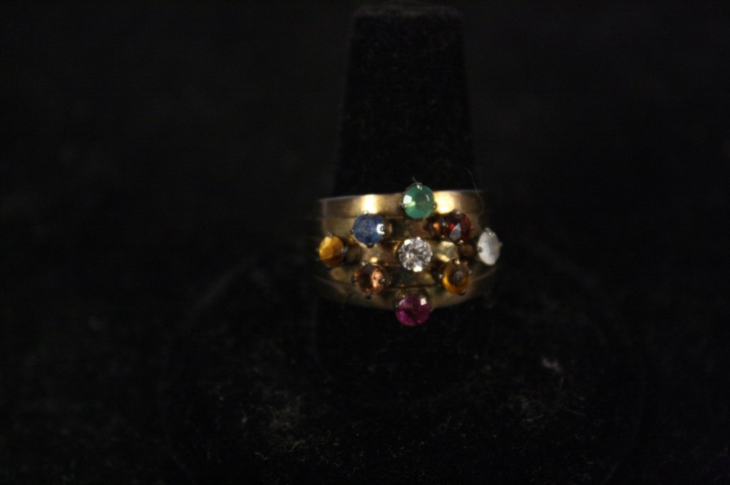 Vintage Multi Gem Kinetic Ring: A vintage multi gem kinetic ring that seperates and comes back together into 5 rings. Measures roughly 3/4 inch on the inside of the ring.