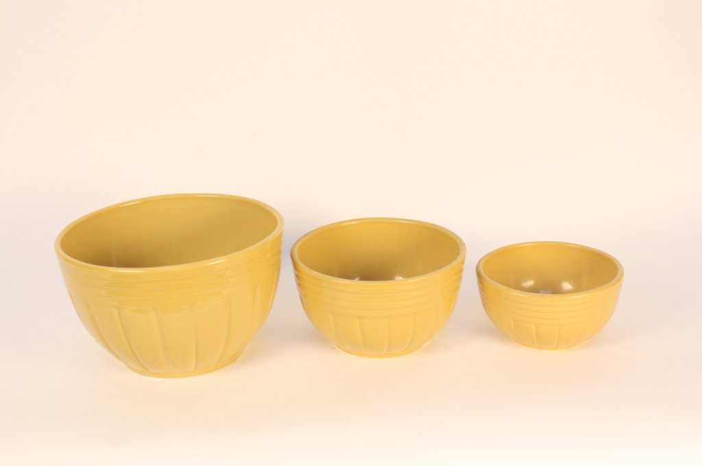 Yelloware Stack Three Bowls and Lidded Casserole: Vintage ringed set of three interlocking bowls and a lidded casserole square pot. All marked and numbered.