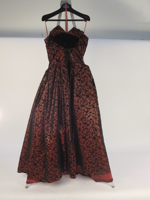 MIGNON ANNE MARIE GABALIS NEW YORK Couture Gown: Red and black strapless designer NIGNON ANNE MARIE GABLIS NEW YORK couture gown, marked MADE IN USA SIZE 12, very good condition, black velvet bow in front, floor length.