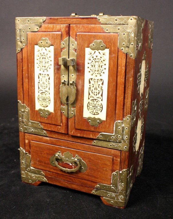 Antique Asian Wood and Bone Jewelry Box: Intricately carved bone inset panels on sides and front with Brass inlay and decorative hardware. Leaf and geometric design motif. Corners wrapped in etched metal. Handle at top, One accessible drawer