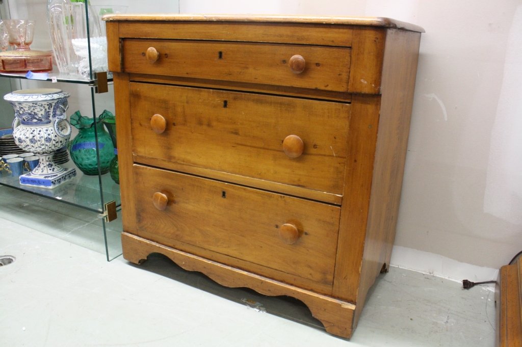 Distressed Wood Nightstand 3 Drawers: Rounded, beveled, corners with wood knobs and carved skirt. Measures 29h x 30w x 17-1/2d