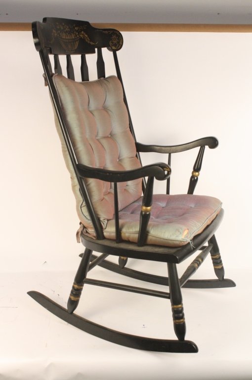 Vintage Black Rocking Chair: A vintage black rocking chair with floral stenciled designs. A great practical chair. Measures 44 x 24 x 27.