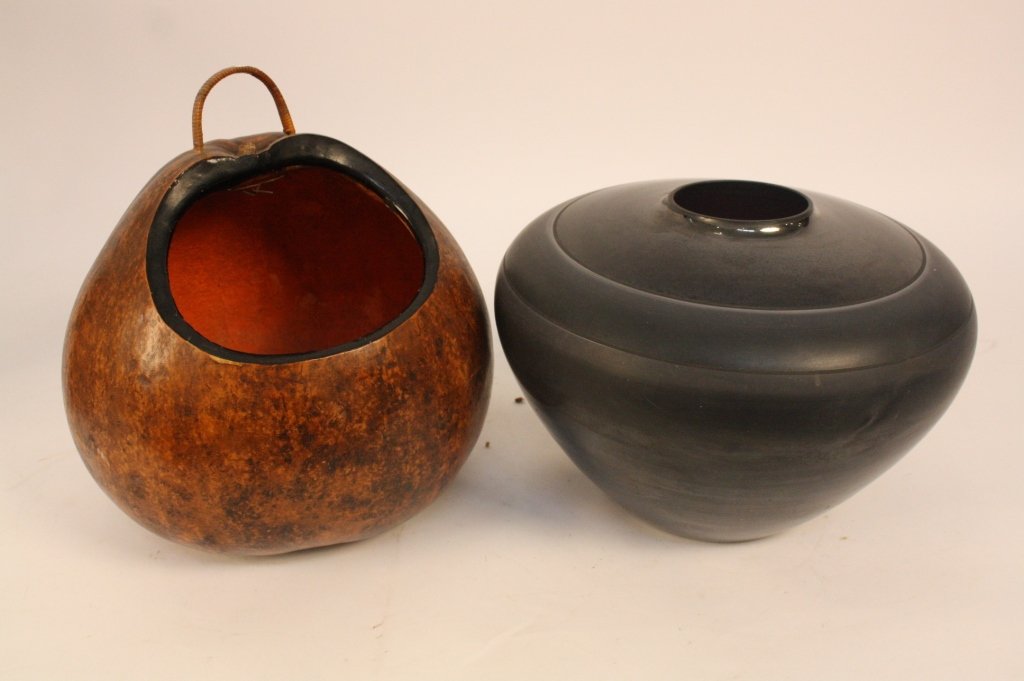 Group Lot THREE Decorative Objects: 20th and 21st century collectibles including a large black glass bowl, a large gourd vessel, a footed black pottery vessel, and a covered basket on chicken wire stand marked AMERICAN HAND BLOWN GLASS.