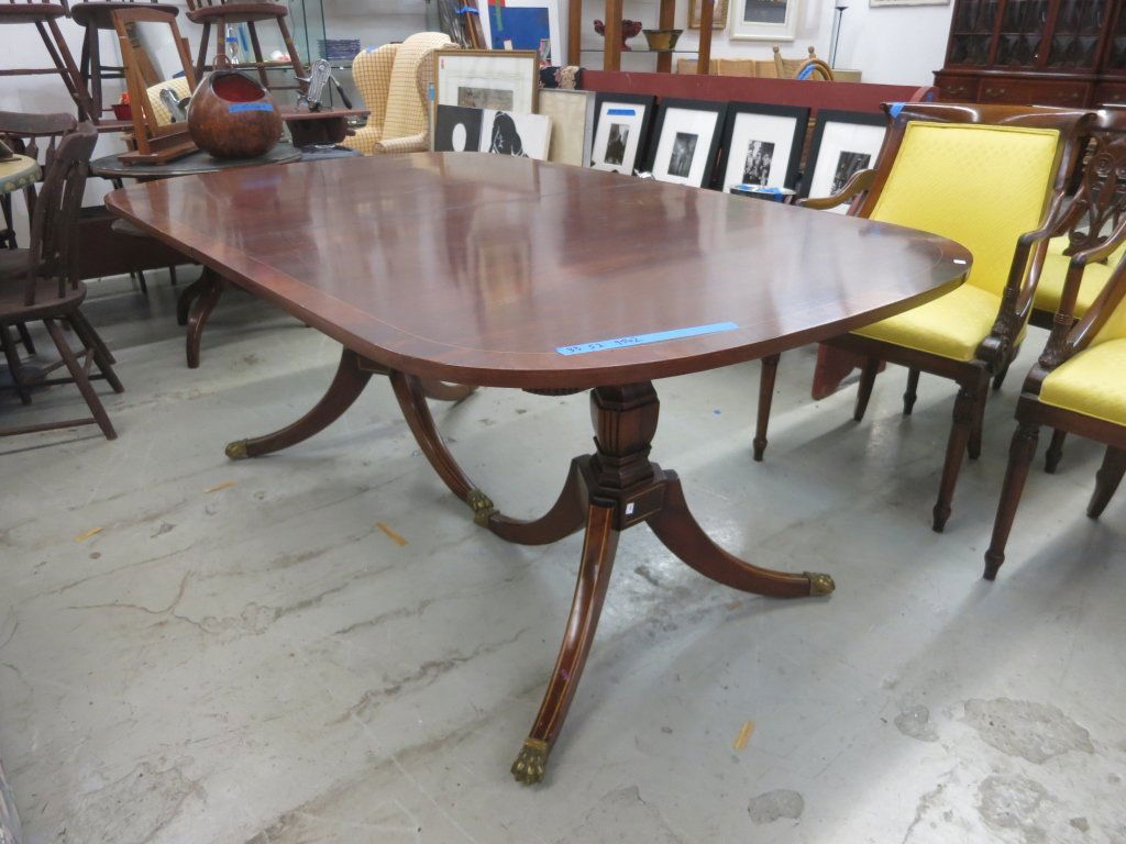 Double Pedestal Mahogany Dinning Table: Mahogany Dining Table with inlaid banding, double pedestal, brass feet and casters. Measures 6 feet length, 44 inches width and height 30 inches. Property of Scarsdale Estate