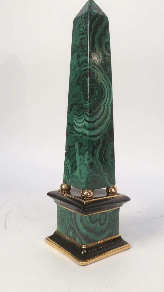 Malachite designed porcelain obelisk: porcelain obelisk painted malachite design with black and gold detailing. Small chip one side. Measures height 21 inches base 5 inches square. Property of Greenwich Connecticut estate