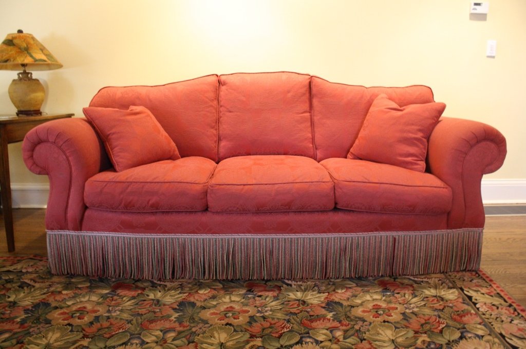 ABC Loose Cushioned Sofa TISSA Fabric: Excellent Condition, three seat red wine cranberry tone on tone sofa. Excellent condition Fringed at base. measures length app 89 inches, depth app 45 inches, and height of back app 37 inches
