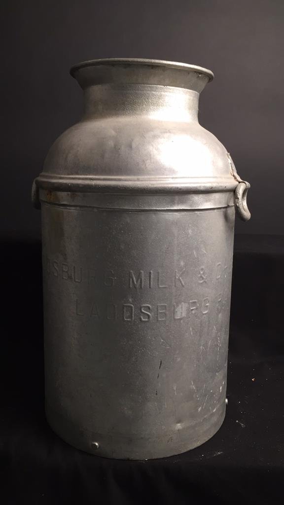 LADDSBURG MILK & CHEESE Vessel: Heavy metal with handles and imprinted with lettering LADDSBURG, PA. Metal rivets and soldering. Measures 23h x 18 diameter. Great umbrella stand.