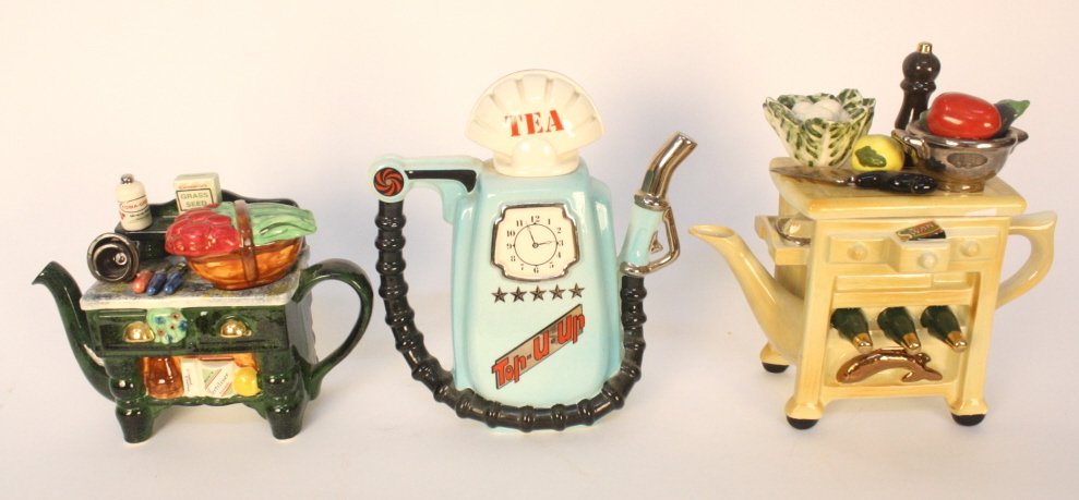 Three vintage English teapots: collectibles. English teapots signed. Vintage counter top and wine storage measures app 12 inches high by 11 inches length signed Arrington designs whit stable Kent, one Aqua painted gas tank with clo