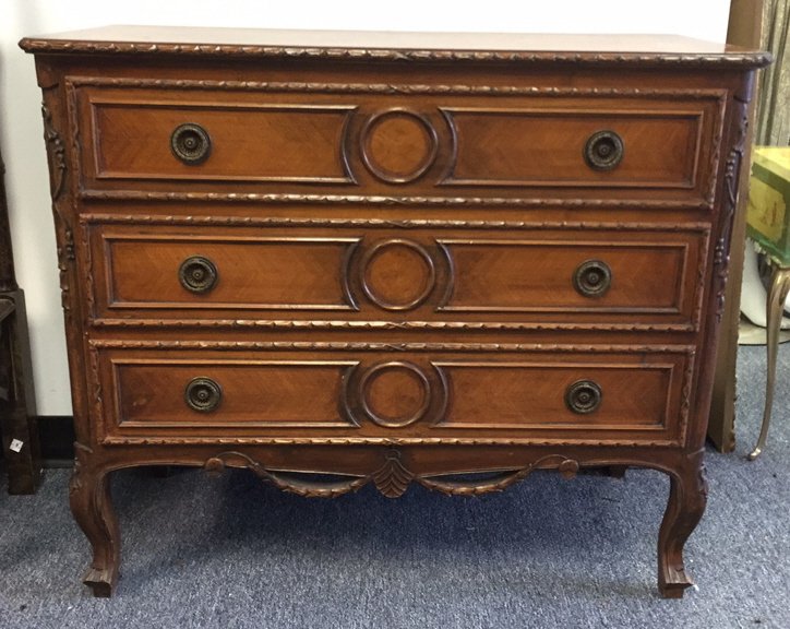 Vintage Three Drawer Dresser: Carved cabriolet legs and bronze hardware. Leaf and bud motif carved on trim and apron. Lined with floral design. Measures 31h x 37w x 17d