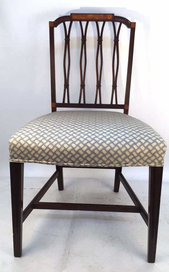 Antique Sheraton Parlor Chair Mahogany finish with: Mahogany finish with Burled inlay on crest rail. Straight tapered legs with H stretcher. Ribbed pattern in carved stiles with cut out fishnet pattern design at back. Fabric in excellent condition. Mea