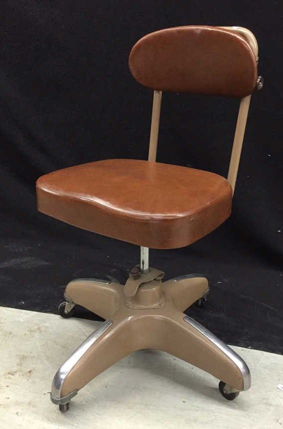 Vintage Office Chair: Old fashioned exam chair with vinyl seat and metal on metal design.