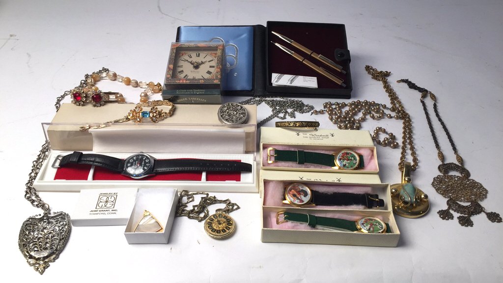 Group Lot Time Pieces and Costume Jewelry: Includes pen and pencil set made in Italy, a clock with tradition handmade in England WM Griggs Guilford, several watched in orig boxes from the Windmill in St. Martin.