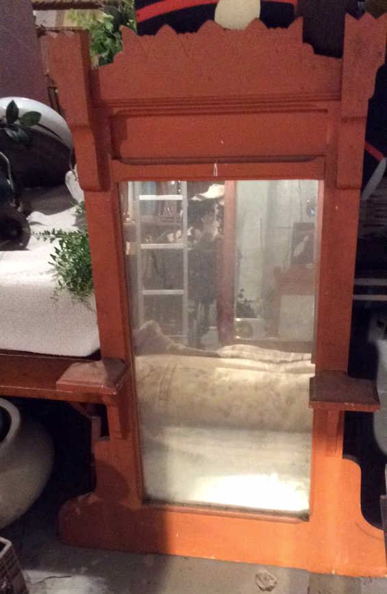 Orange Wood Painted Vintage Mirror: this decorative mirror is a vintage wood mirror that was painted orange has two beams which appears that you can put something on the mirror of some sort , mirror could use some cleaning wood could us