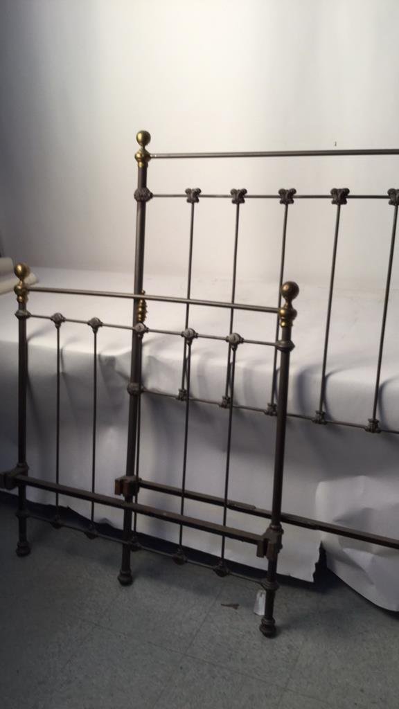 Vintage Railed Twin Bed Frame: Iron and brass twin bed frame with maple leaf and butterfly designs. Head board measures 59 inches high by 38 inches wide. Foot board measures 36 inches high by 38 inches wide