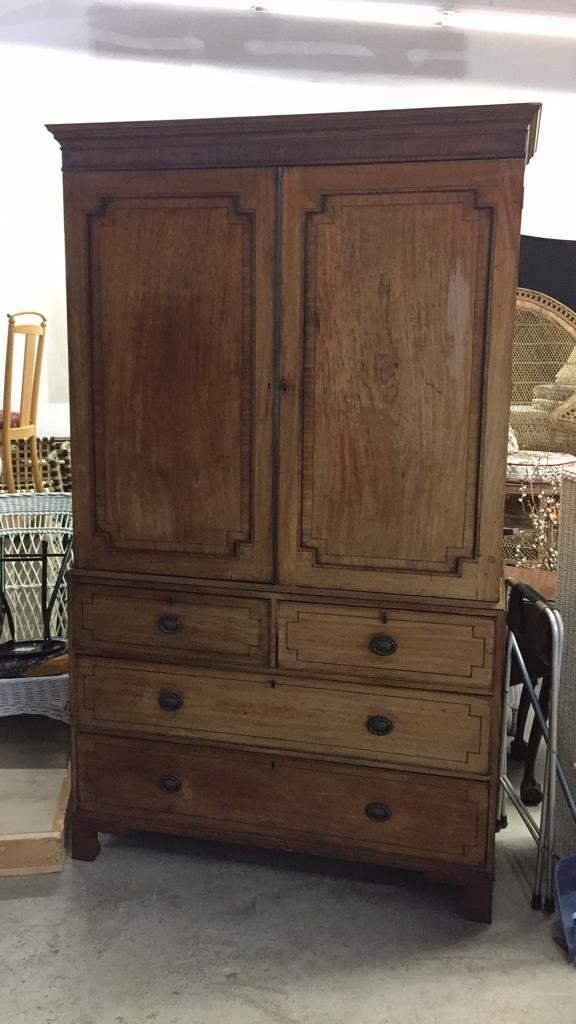 Oversized Wardrobe Bronze Trim: Carved edges on feet with reeded footboard and Burled wood inlay. Border pinstripe design with locking drawers and doors with keyholes and skeleton key. Double doors open to four pull out shelves with