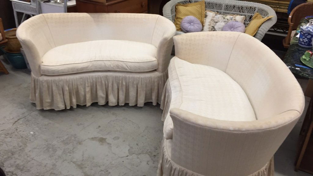 Pair Petite Vintage Skirted Settees: Single seat cushions in kidney bean shape with rounded arm design and bow back. Sun faded upholstered geometric patterned fabric with decorative pipping. Feels like down feather seat cushion fillers.