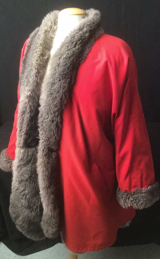 Red Cotten Fur Lined Coat: Red Cotten Fur Lined Coat, ladies Large, A'line shape, fur Trimmed collar and opening, also sleeves fur trimmed as well.