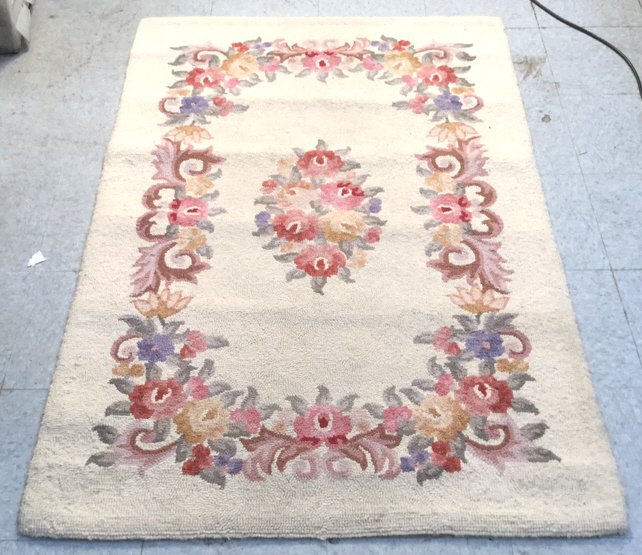 Vintage Handmade Floral Area Rug: Vintage handmade floral carpet, mostly tan with scrolling floral inset border and center, used, ware visible, no rips holes or large stains, measures in inches 40x62