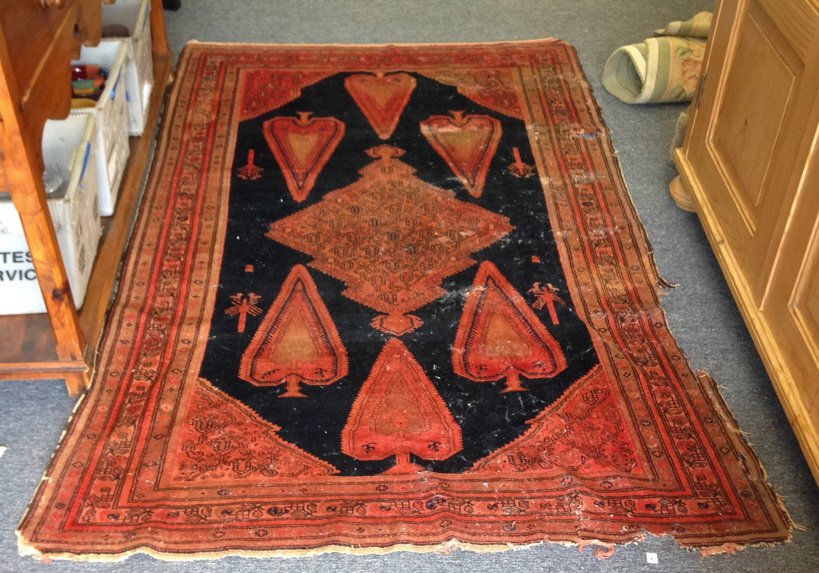 Antique Hand Made Rug: Antique hand made rug, black and red colors, extreme ware, rips and holes, measures in inches 49x77