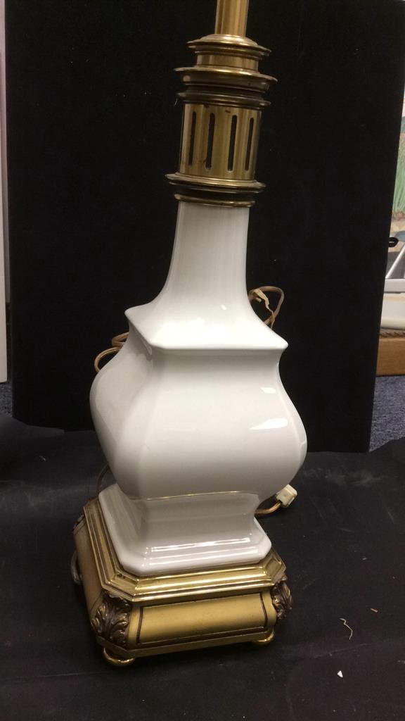 White Porcelain and Brass Lamp: translucent white porcelain in vase shape on brass base with bun feet reticulate do brass details measures 33 inches high 6 inch square base