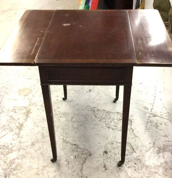 Drop leaf Pembroke table with banding: Mahogany Single drawer brass hardware with casters on legs measures 26H x 31W x 25D