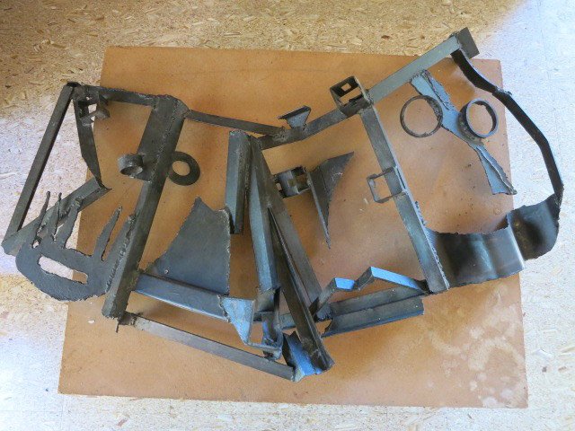 HENRIETTA KARASIN Abstract Metal Sculpture: Abstract Welded and Forged Metal Sculpture. Four Faces. Welded, cut, forged and twisted technique in BRUTALIST Style. Executed during the 1970's-early 1980's. Incised KARASIN on base. 34h x 50w x 8 in