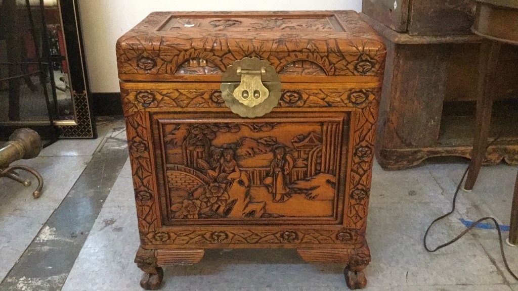 Vintage Asian Style Chest: Petit wood carved chest with floral boarders and Asian Figures. Claw feet. Brass hardware. Measures 20 inches high by 16 inches wide by 11 inches deep