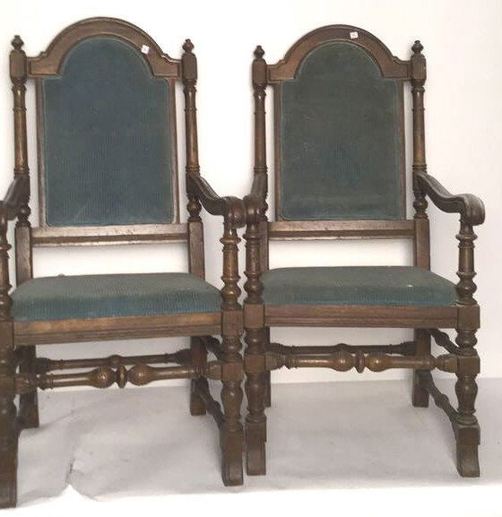 Pair of Antique Mahogany Arm Chairs: Pair of carved mahogany antique dinning arm chairs with green upholstered seats and backs. Condition reflects age. Carved spindles and legs. Cushion on seat back needs to be secured. Each measures 44