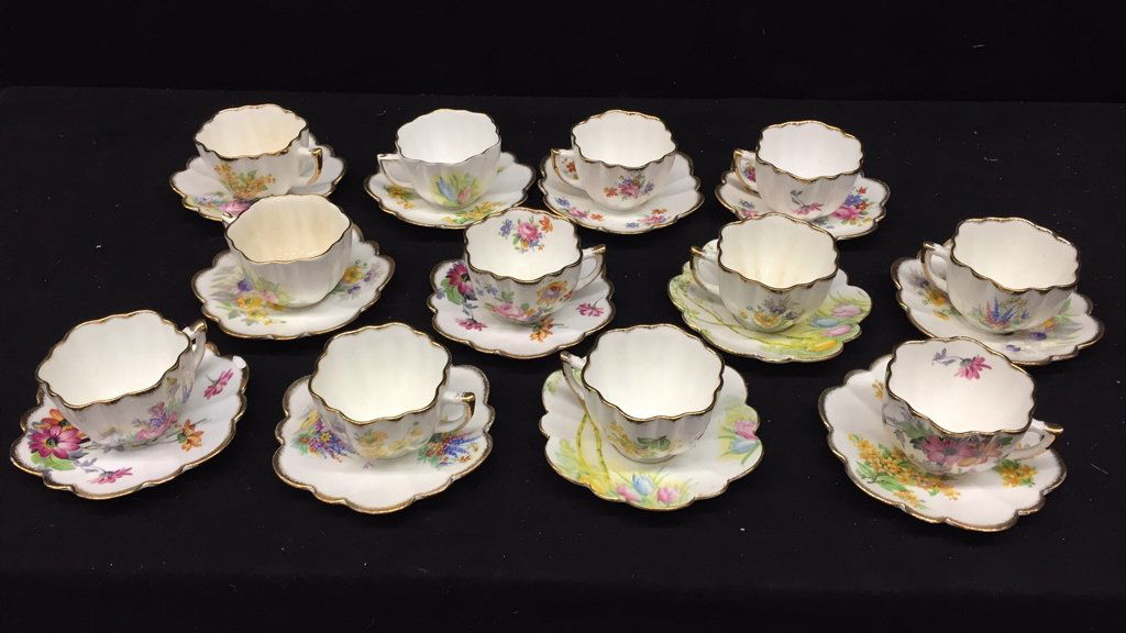 MELBA BONE CHINA Fine Grade Made in England: 12 Vintage hand painted, scalloped edges with gold leaf trim. Mixed matching cups and saucers. Diameter of saucer is 5 inches one has chip on trim.