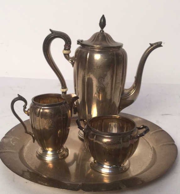 Sterling WC 29 Tea Service Set: Set of 4 Sterling silver tea service. Includes tea pot, creamer, sugar bowl and tray. Tray measures 11 inches wide. Stained condition. "S" insignia. Marked Sterling WC29