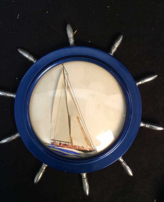 mixed media sailboat in ship wheel frame: vintage artwork sailboat in blue and chrome nautical ships wheel frame. Measures app 10 inch diameter
