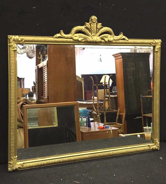 Metallic Gold Framed Mirror: Mirror in a metallic gold painted frame measuring in inches 33l x 29h, mirror and frame in good condition, writing on the back of frame, wire on the back for hanging