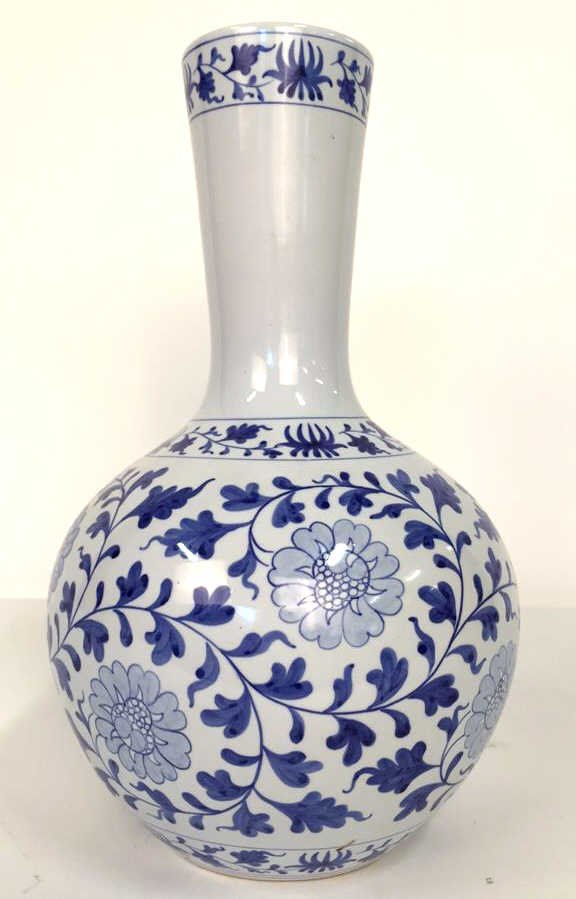 Large Blue and White Vase From Taiwan: Floral motif with leaves, vines and blossoms. White ground marked on bottom. Excellent condition. Measures 17 x 11 in diameter
