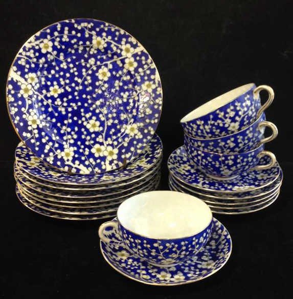 18 Piece Vintage Blue Tea China Set: Lot includes 18 pieces matching maker and matching pattern blue hand painted base on white China with white and yellow flowers design with gold painted rim and oranges marking on back of half sun with