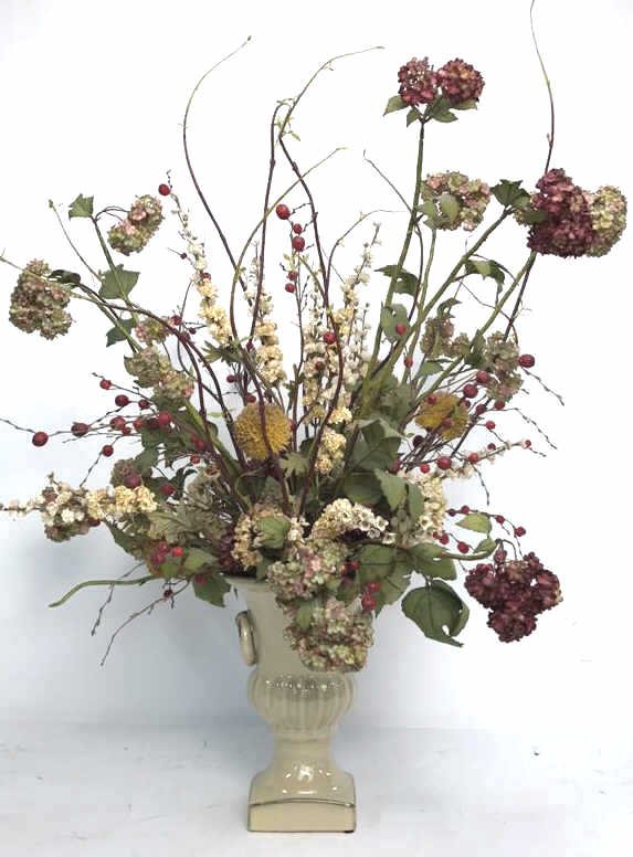 Ceramic Urn with Dried Flower Bouquet: Round ceramic handles with arrangements of autumn colored flowers. Urn in excellent condition measures 12 inches high x 5 x 5 at base, Purchased at Ethan Allen