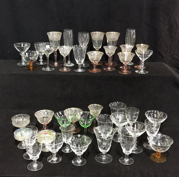 Assorted Glass Stemware Unsigned: Collection of unsigned miscellaneous glass 40 pieces some etched with gold leaf trim design. Stemware includes champagne flutes, wine glasses, liquor with geometric stem design.