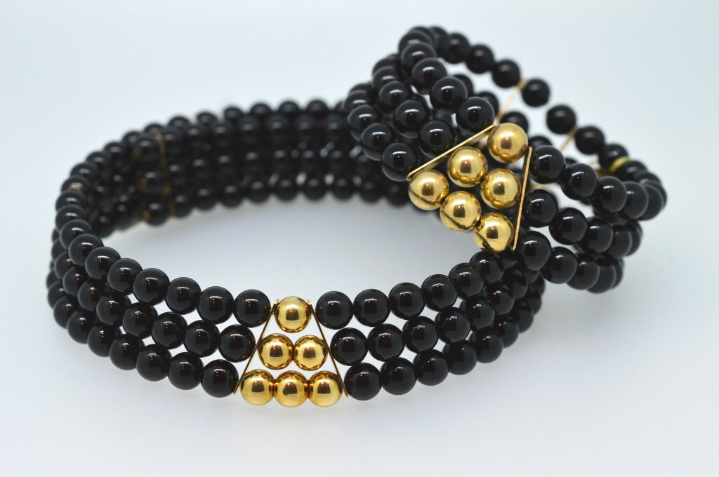 Black Onyx & 14K Gold Choker Necklace Bracelet Set: A standout striking set crafted with rich Black Onyx Beads featuring 14K Gold Beads on both the Choker Style Necklace and companion Cuff Bracelet. Both adjustable. New merchandise from old stock.