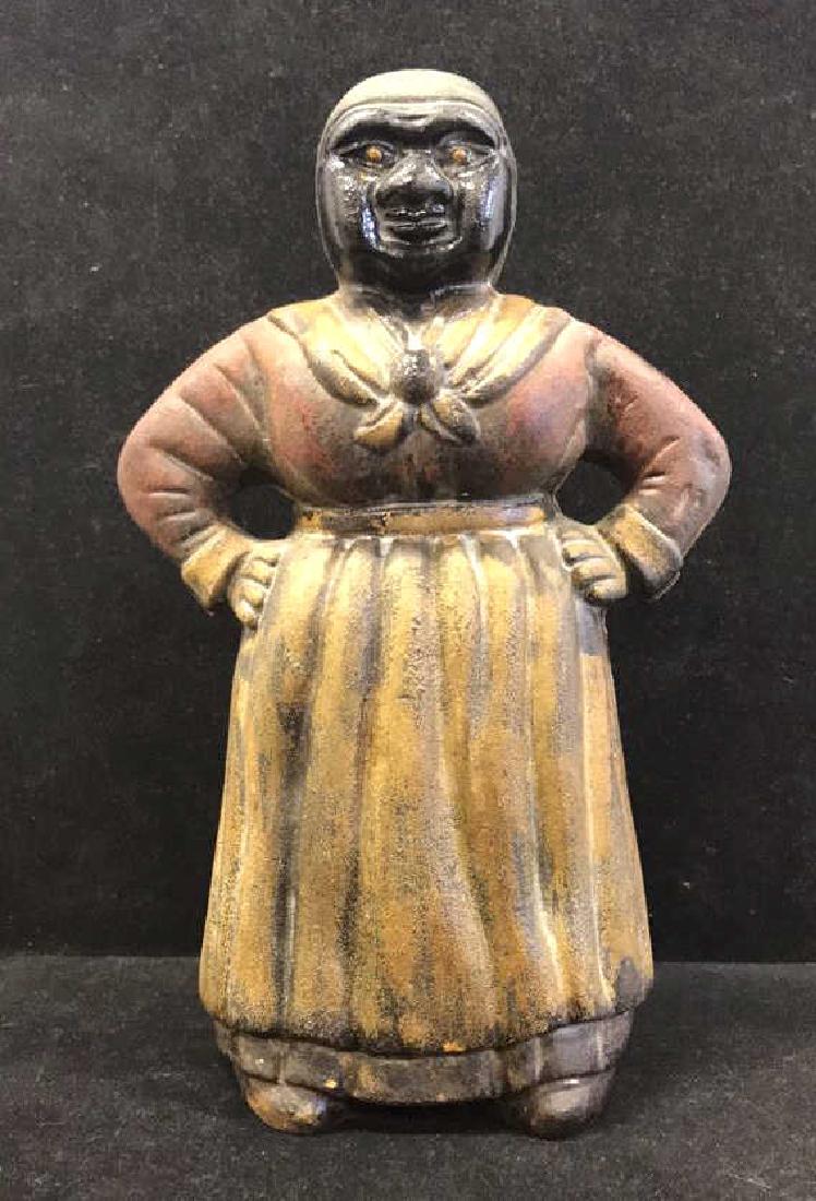 Antique Cast Iron Aunt Jemima Piggy Bank: Antique Cast Iron Aunt Jemima Piggy Bank, coin slot in back, seem where front and back were joined, color fading but visible, folk art, condition consistent with age, measures in inches 4x7x11