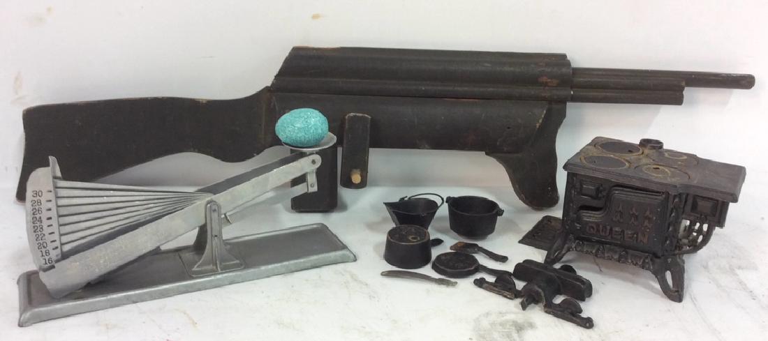Vintage Folk Art Group Lot: Lot includes toy cast iron stove with marking for Queen, Pots and pans iron accessories with open and close doors, removable burners. Carved wood folk art gun rifle painted green black , vintage kitch