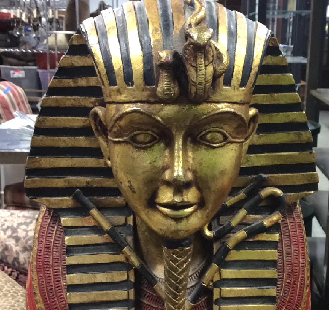 King Tut Painted Wood Cabinet: Wooden cabinet carved and painted with mummy king tut figure. Gold red orange accents, hinged door opens to shelves. Measures height 27 inches depth 11 inches width app 9 inches