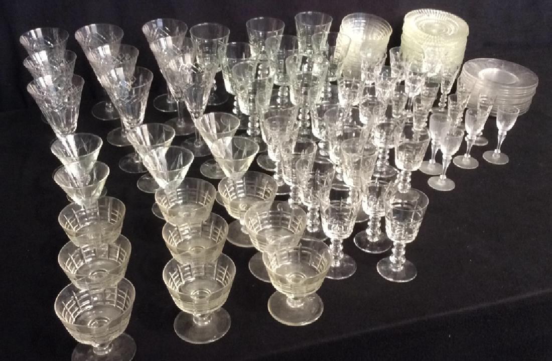 Group Of Vintage Glassware: Group of Vintage glassware. 96 piece ranging from cut glass, footed water, wine, shot, desert and more. Also included are desert bowls, saucer plates and desert plates. Largest glass measures 7" h x 3